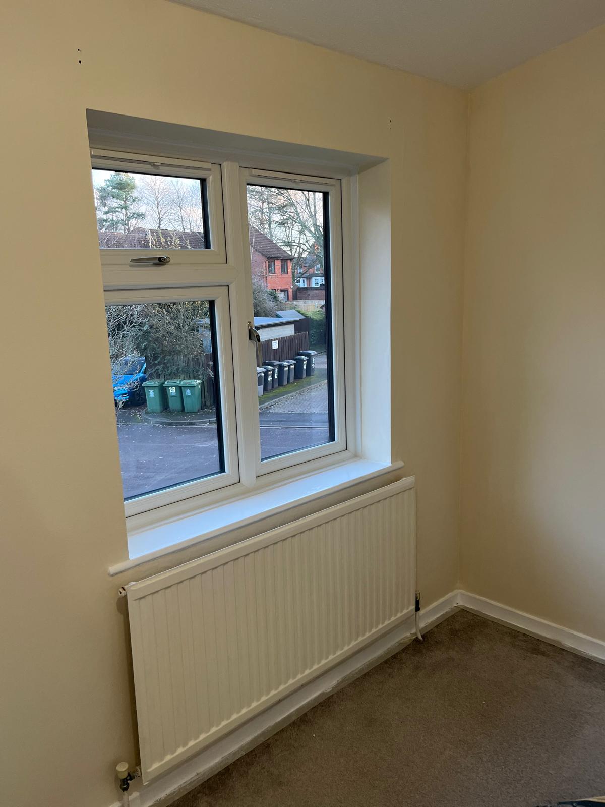 Bedroom window with freshly painted reveal and sill