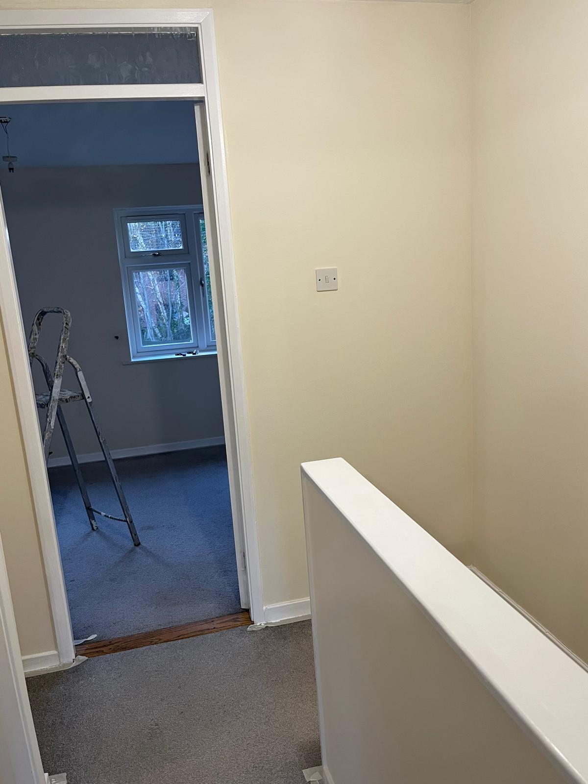 Landing walls freshly painted with white door frame