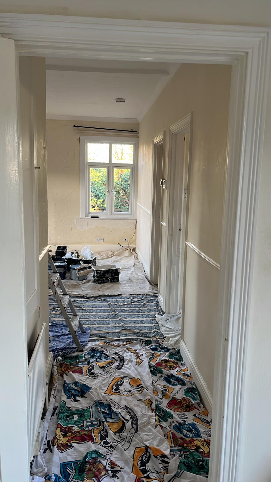 Hallway floor covered with dust sheets during decorating