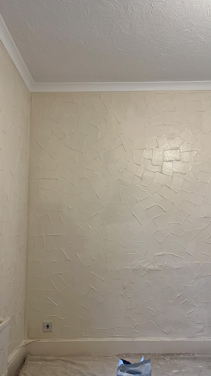 Textured wall freshly painted in soft cream