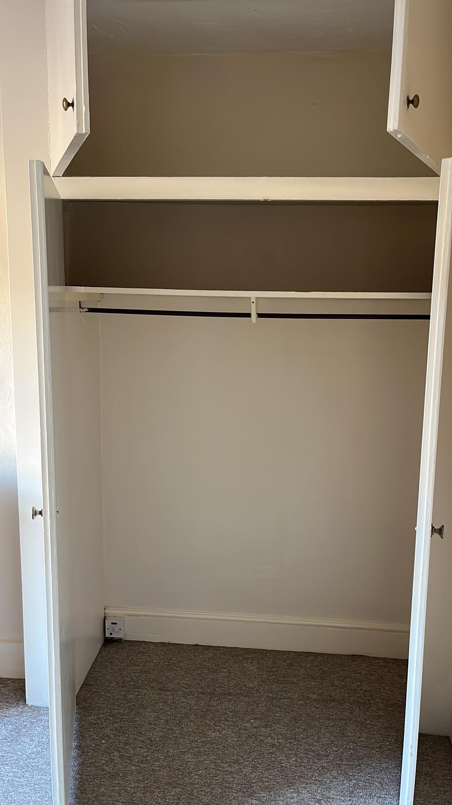 Inside of a built-in wardrobe freshly painted